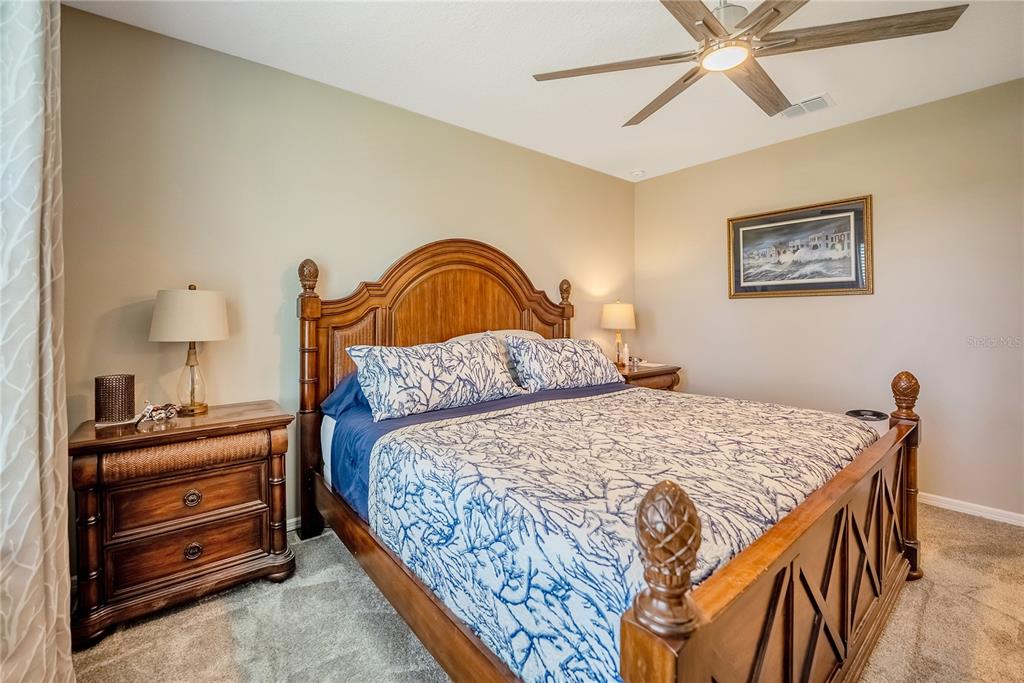 8344 Southwest 54th Loop Ocala, FL 34481 - Photo 12 of 36 a bedroom with a bed and dresser