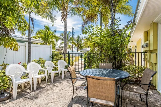 a view of outdoor dining space with a table and chairs