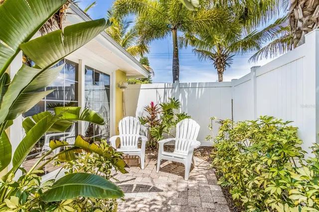 a view of a chairs and table in the backyard