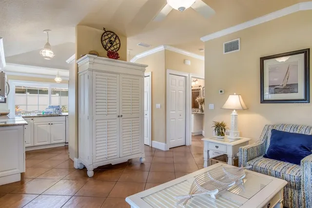 a hall way with furniture a rug and a bathroom