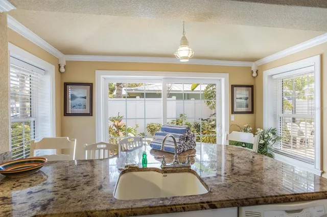 a dining room with wooden floor and glass window