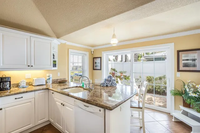 a kitchen with sink and cabinets