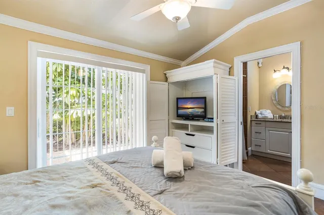 a bedroom with furniture and a flat screen tv