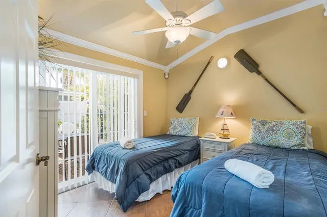 a bedroom with two beds and wooden floor
