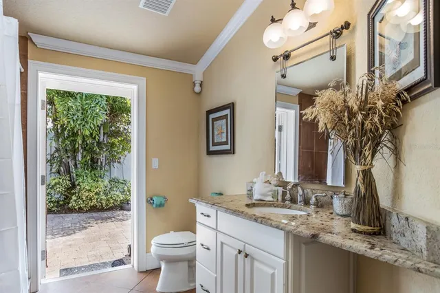 a bathroom with a granite countertop sink toilet and shower