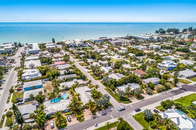 an aerial view of a city with ocean view