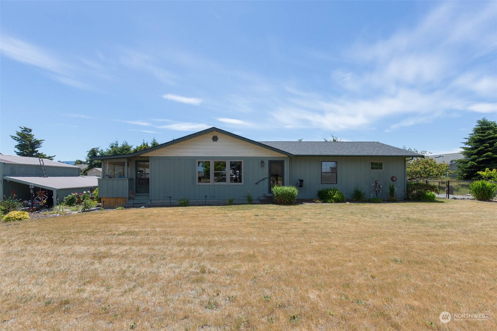60 Klahhane Road Sequim, WA 98382 - Photo 2 of 36 a front view of house with yard and trees in the background