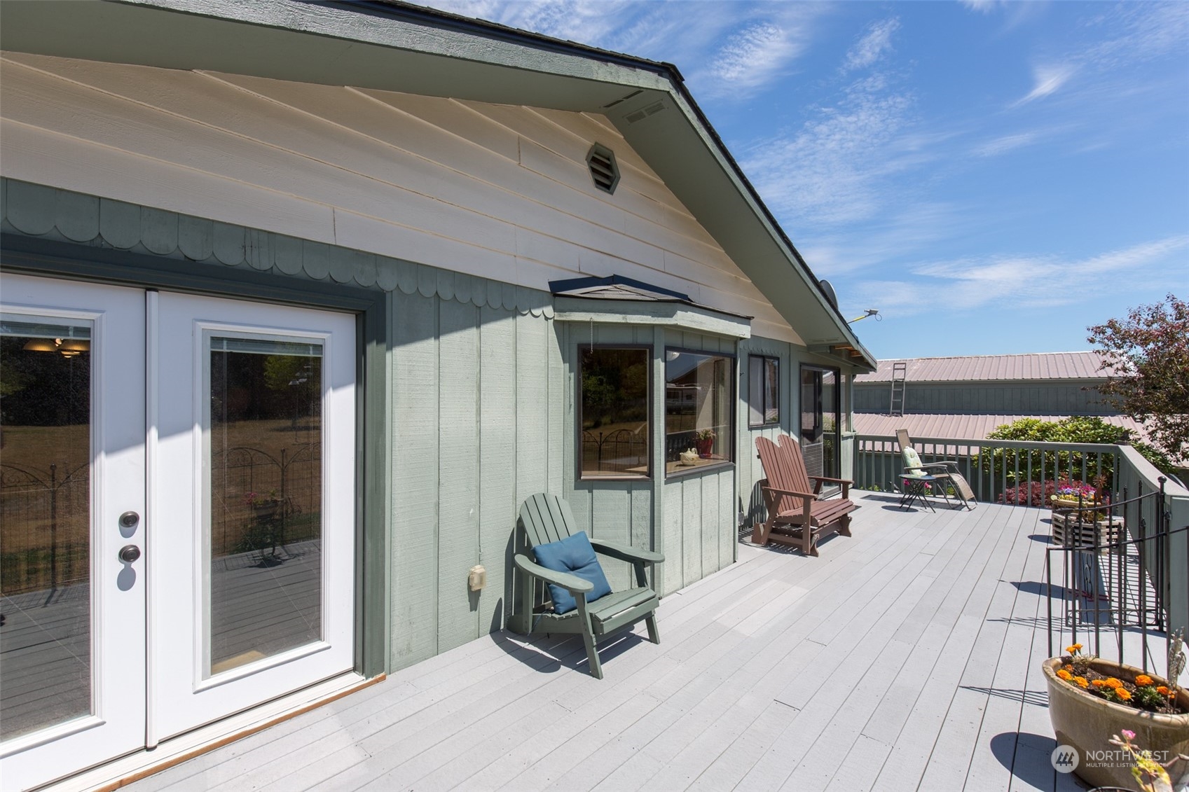 60 Klahhane Road Sequim, WA 98382 - Photo 21 of 36 a view of a patio with table and chairs near a barbeque