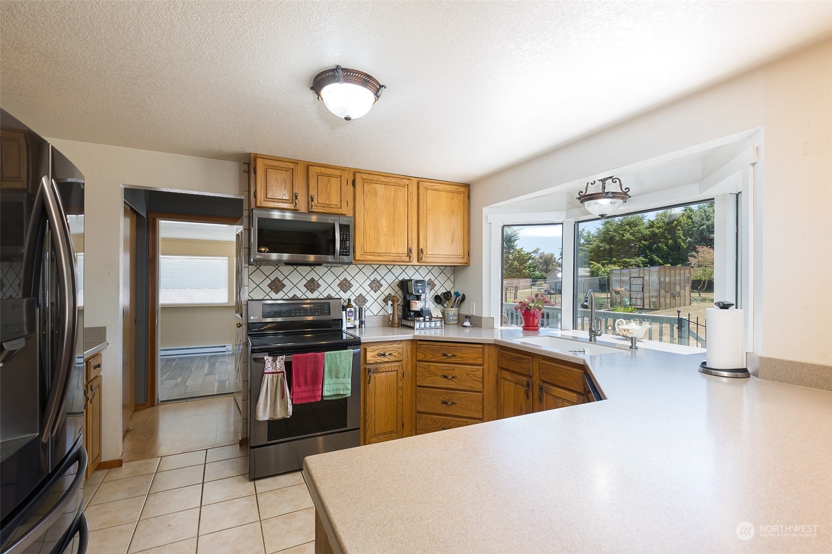 60 Klahhane Road Sequim, WA 98382 - Photo 7 of 36 a kitchen with stainless steel appliances a refrigerator sink and stove