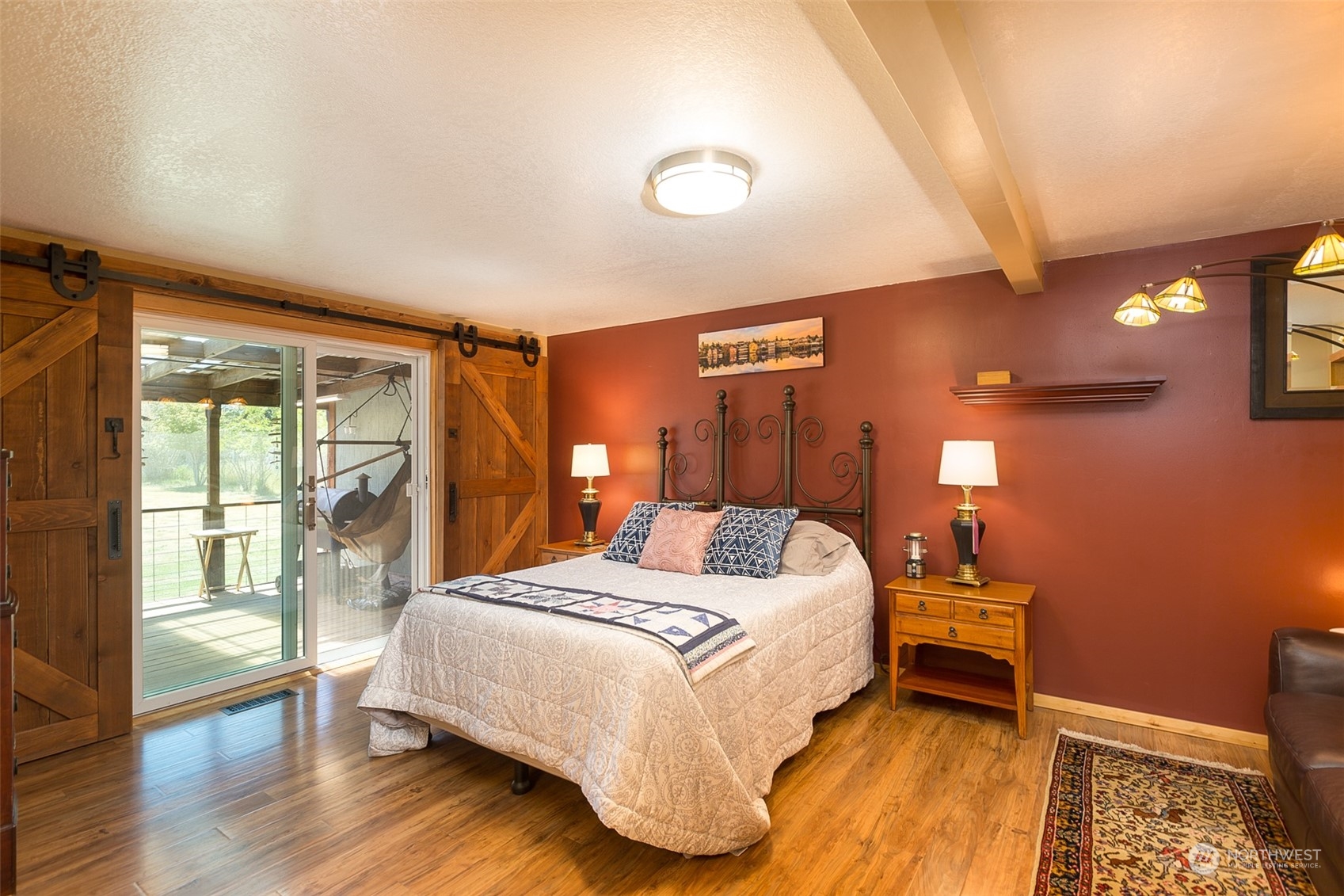 60 Klahhane Road Sequim, WA 98382 - Photo 10 of 36 a bedroom with a bed and wooden floor
