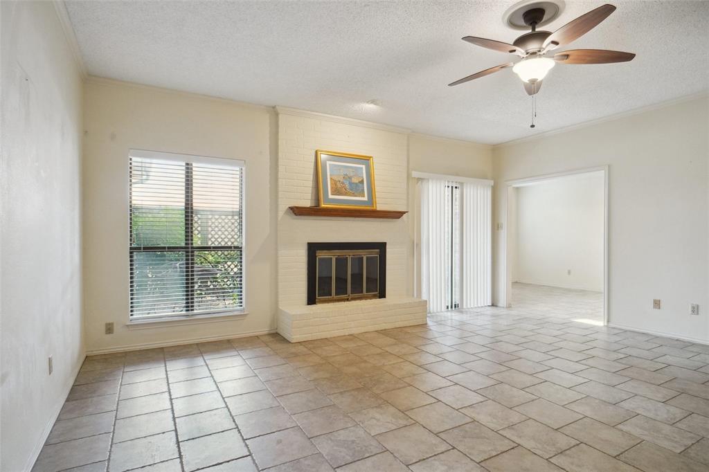 5717 Ridgerock Court Fort Worth, TX 76132 - Photo 2 of 20 a view of an empty room with window and chandelier fan