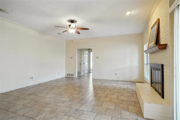 a view of an empty room with a fireplace
