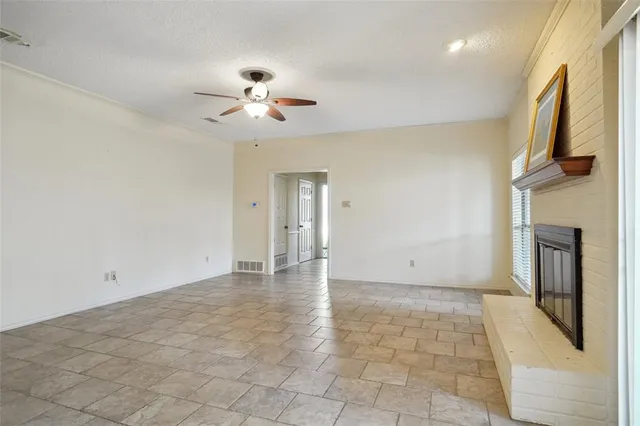 a view of an empty room with a fireplace