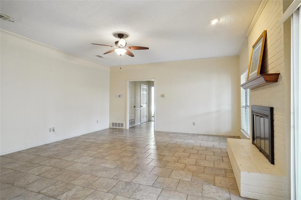 5717 Ridgerock Court Fort Worth, TX 76132 - Photo 3 of 20 a view of an empty room with a fireplace