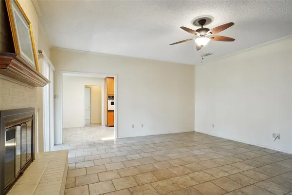 an empty room with fan and windows