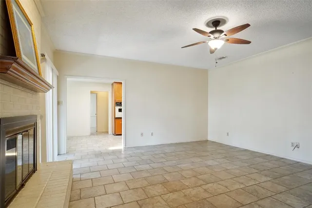 an empty room with fan and windows