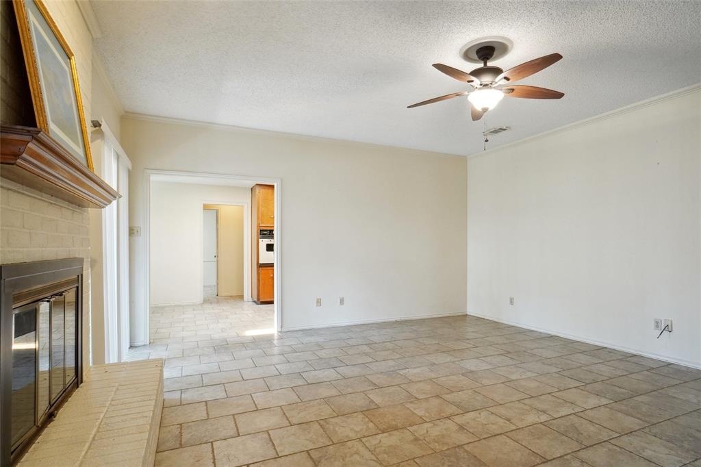5717 Ridgerock Court Fort Worth, TX 76132 - Photo 4 of 20 an empty room with fan and windows