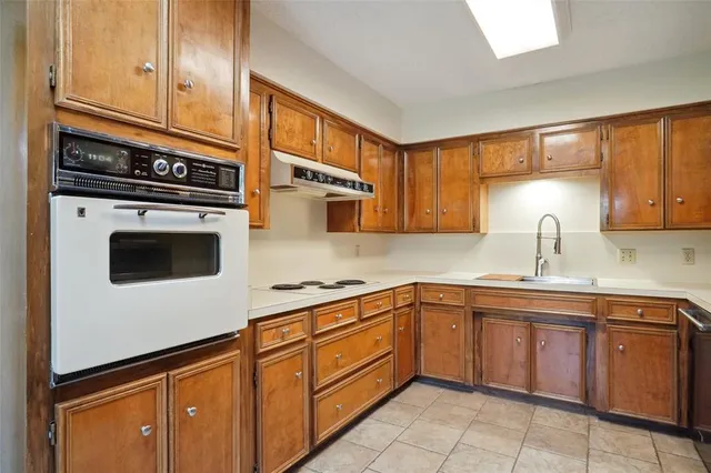 a kitchen with stainless steel appliances granite countertop a sink and cabinets