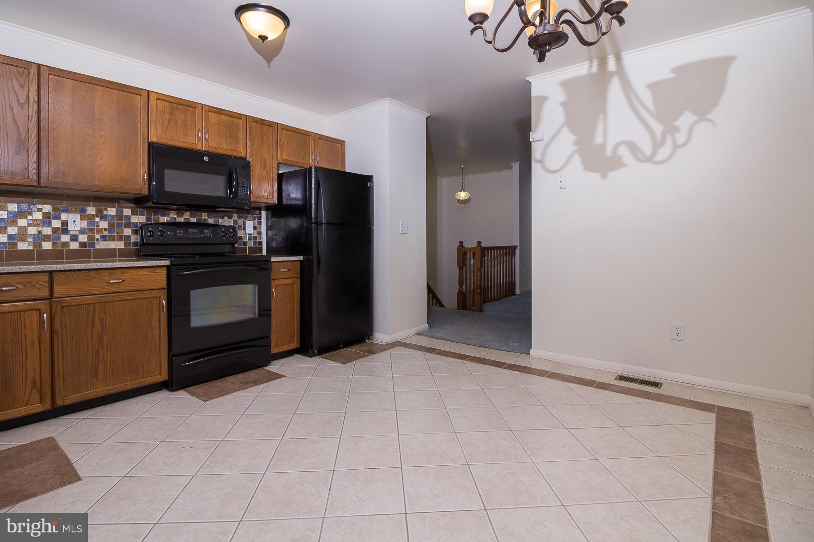 1208 Java Place Landover, MD 20785 - Photo 2 of 19 a view of a kitchen with stainless steel appliances granite countertop a stove cabinets and a refrigerator