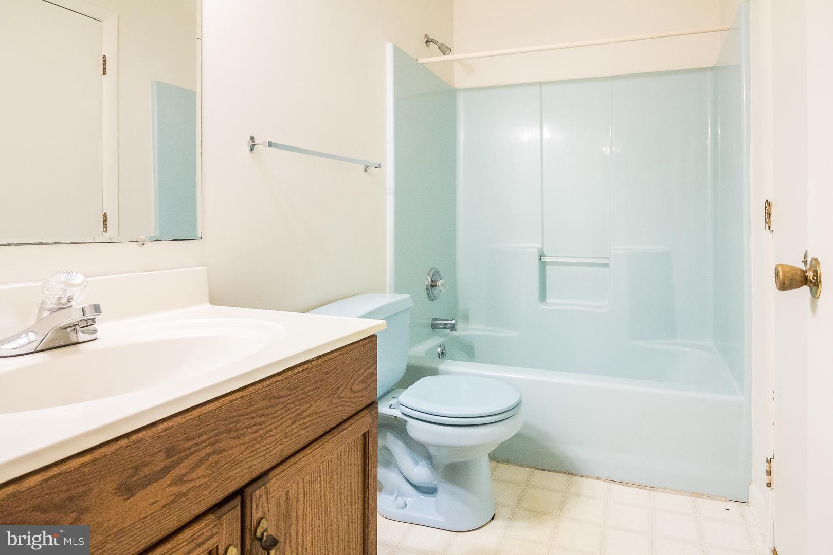 1208 Java Place Landover, MD 20785 - Photo 12 of 19 a bathroom with a sink a toilet and shower