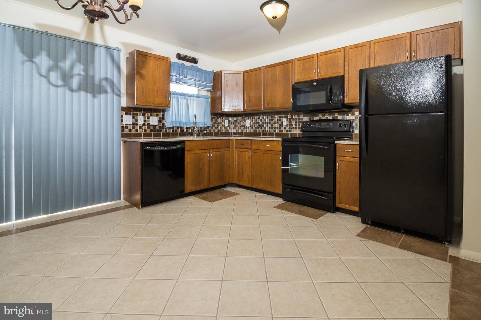 1208 Java Place Landover, MD 20785 - Photo 3 of 19 a kitchen with stainless steel appliances a refrigerator and a stove top oven