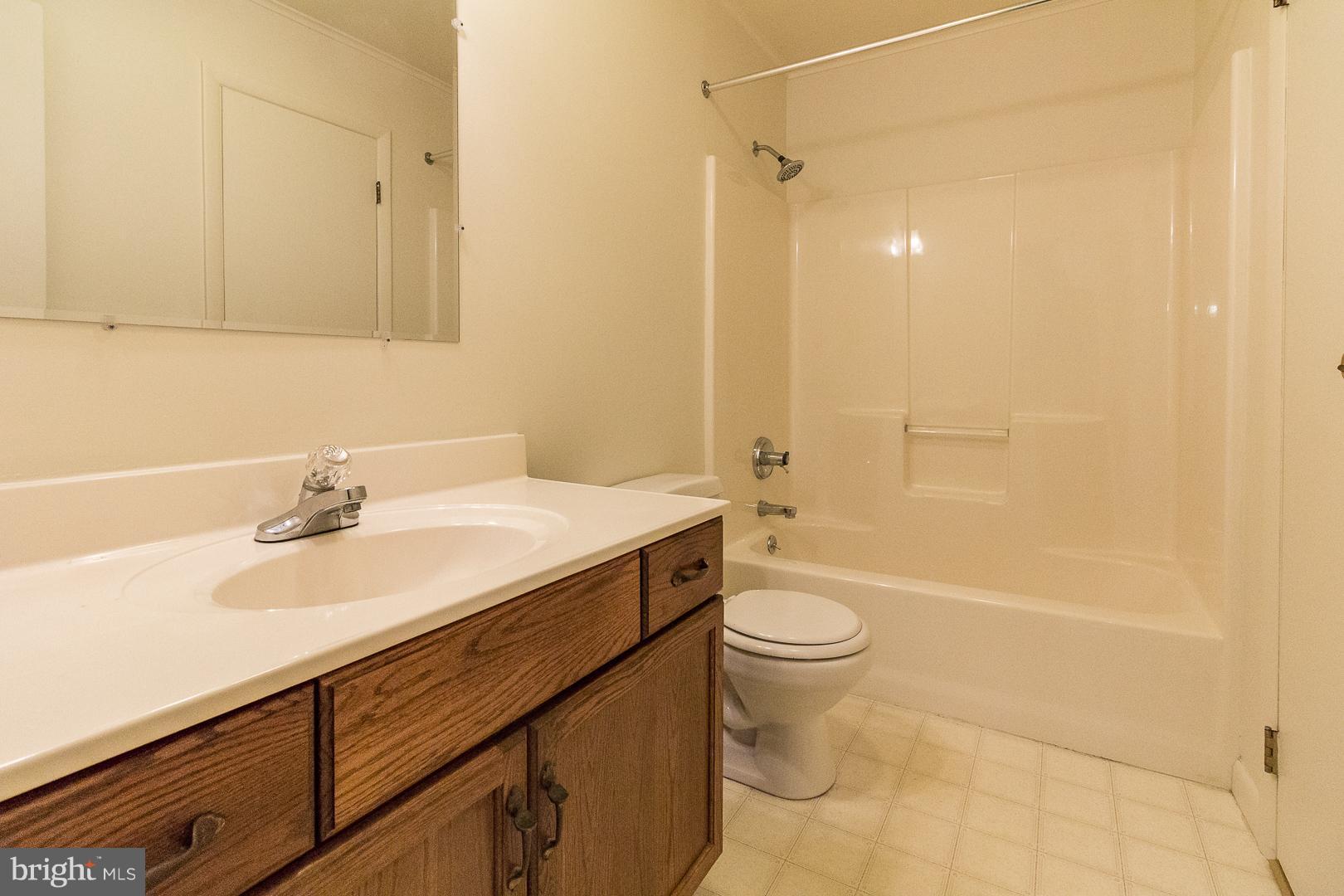 1208 Java Place Landover, MD 20785 - Photo 5 of 19 a bathroom with a sink a toilet and shower