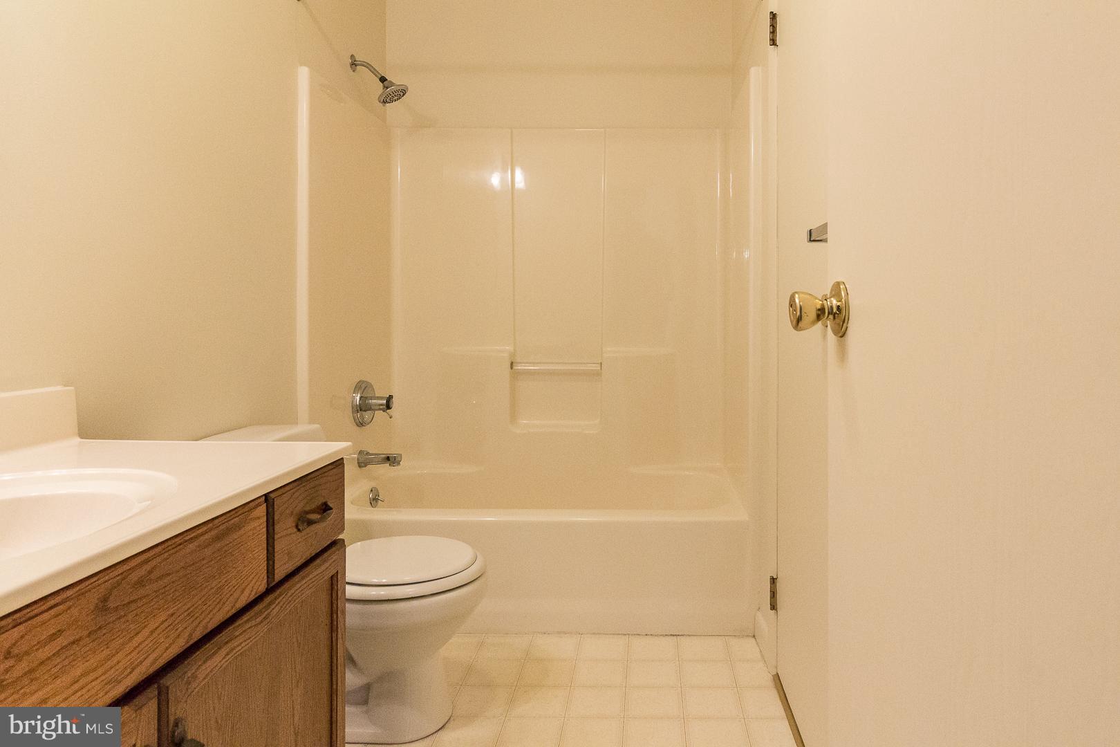 1208 Java Place Landover, MD 20785 - Photo 6 of 19 a bathroom with a granite countertop sink a toilet and shower