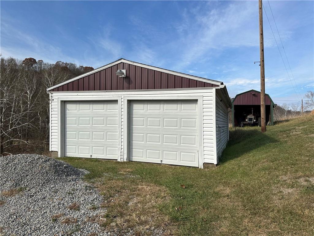 128 Buckland Road Wind Ridge, PA 15380 - Photo 6 of 34 a front view of a house with a yard
