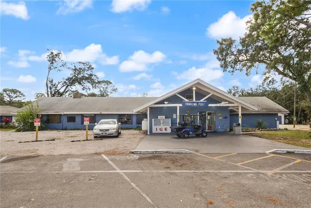 a view of a swimming pool with a yard and a fountain