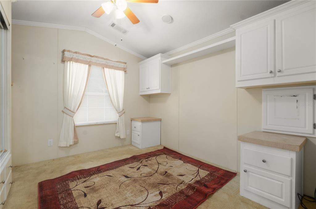 3000 Clarcona Road, Unit 1218 Apopka, FL 32703 - Photo 5 of 22 a view of a livingroom with wooden floor and cabinet