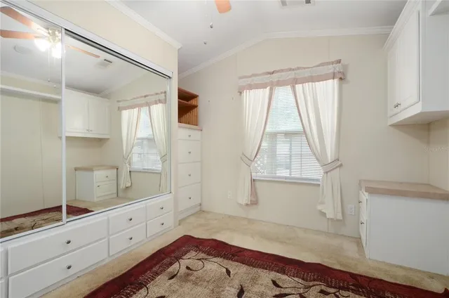 a spacious bedroom with a bed and a window