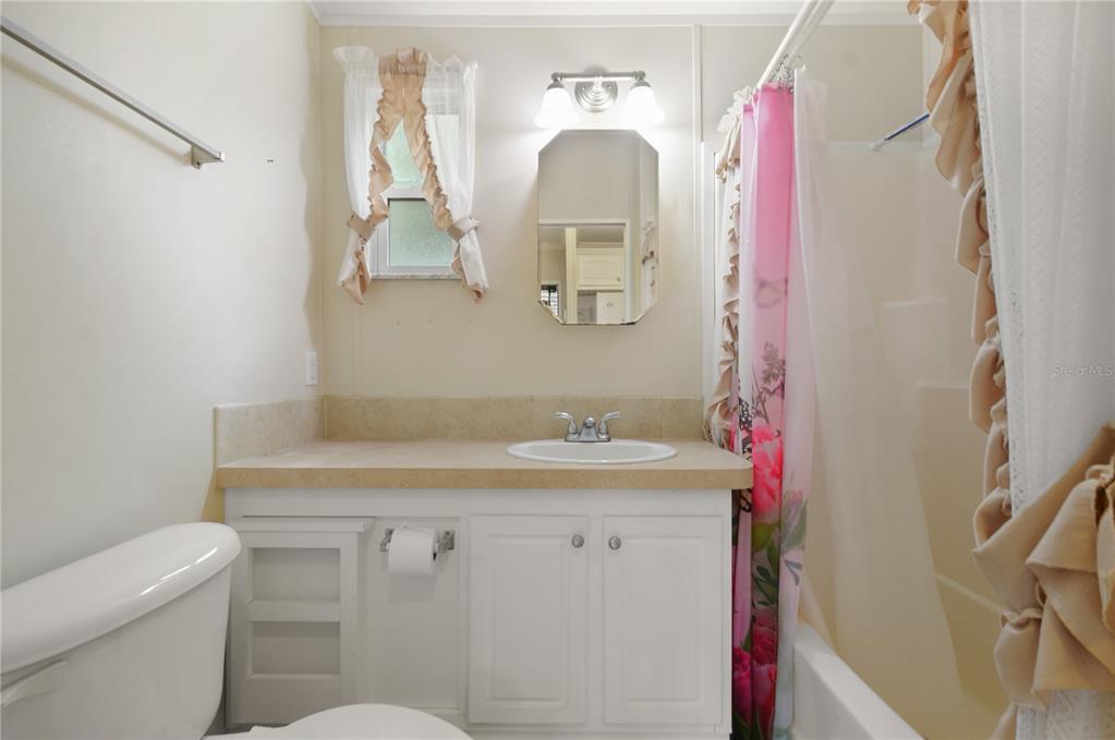 3000 Clarcona Road, Unit 1218 Apopka, FL 32703 - Photo 8 of 22 a bathroom with a sink toilet and mirror