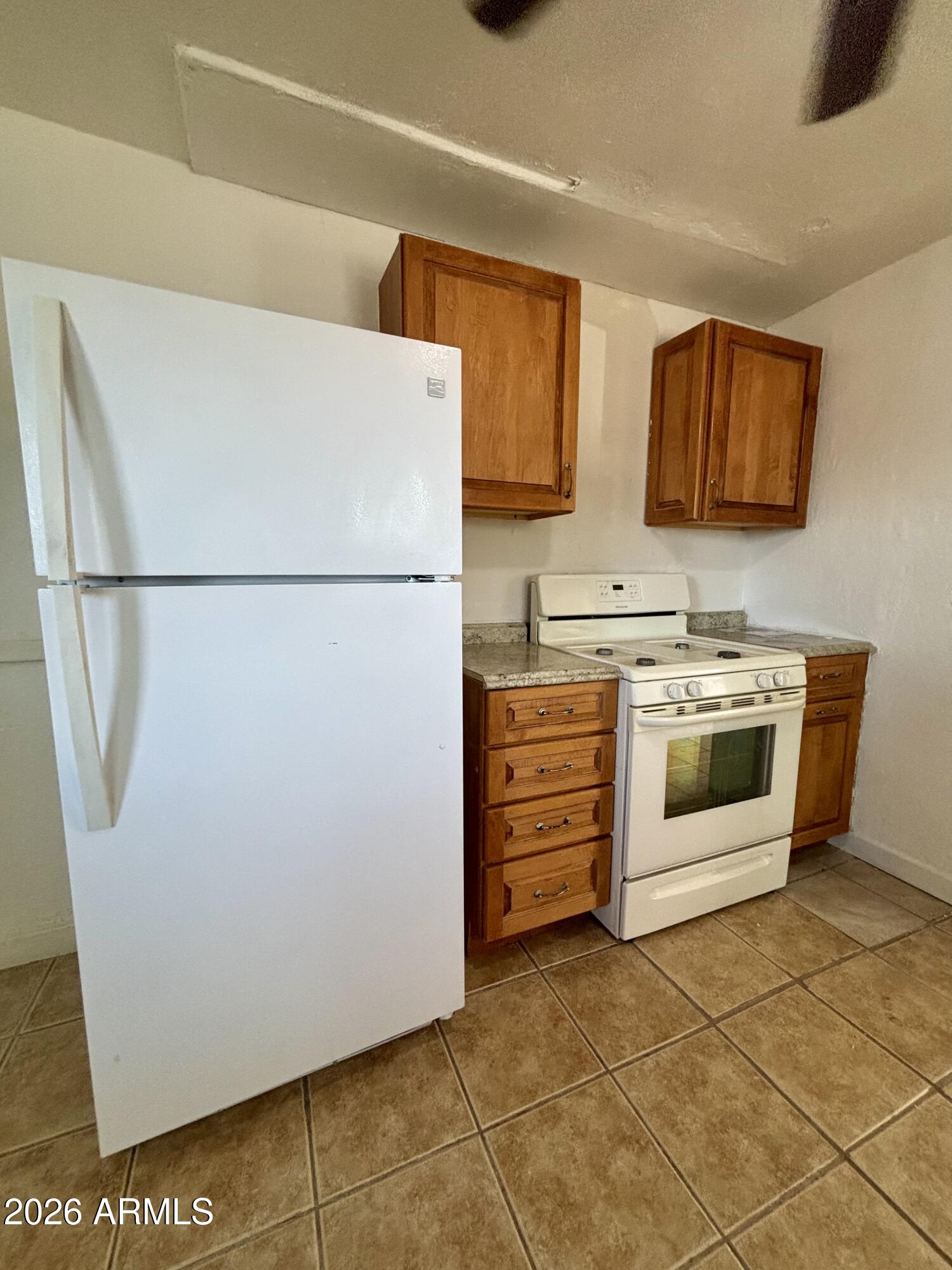 3036 West Almeria Road Phoenix, AZ 85009 - Photo 5 of 20 a white refrigerator freezer and a stove sitting inside of a kitchen