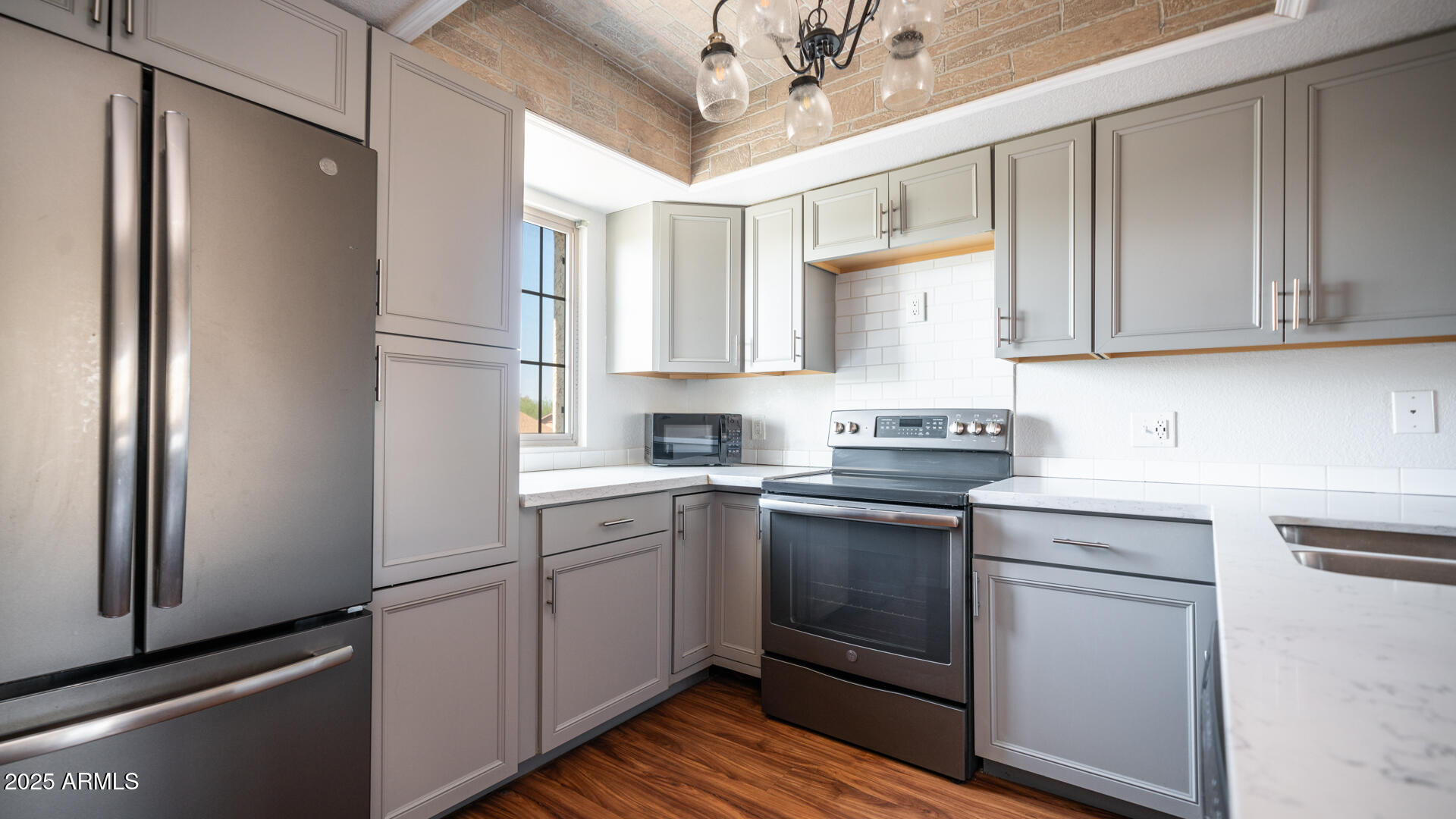 2020 West Union Hills Drive, Unit 246 Phoenix, AZ 85027 - Photo 12 of 23 a kitchen with stainless steel appliances granite countertop a refrigerator sink and cabinets