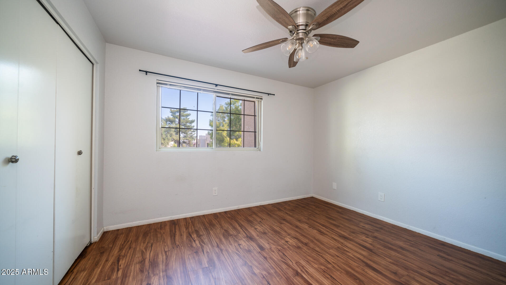 2020 West Union Hills Drive, Unit 246 Phoenix, AZ 85027 - Photo 16 of 23 an empty room with a window and a ceiling fan