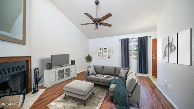 a living room with furniture a flat screen tv and a fireplace