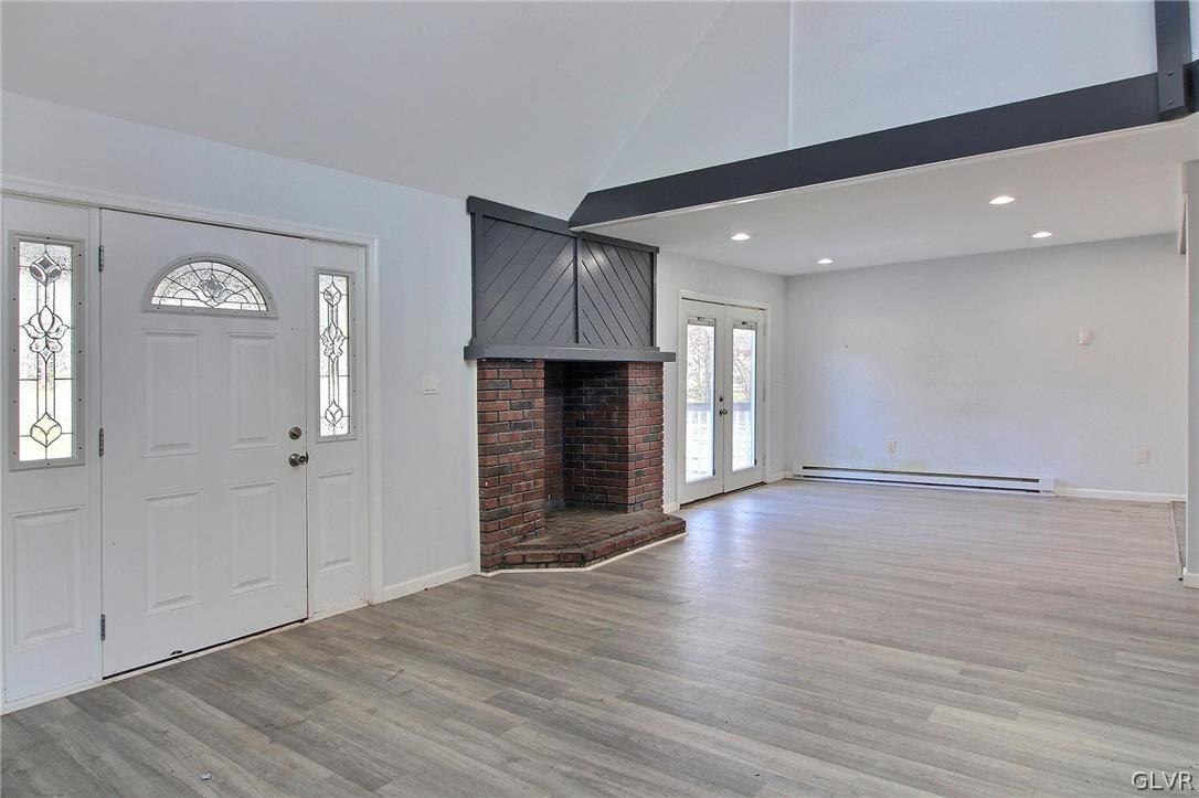2270 Long Pond Road Long Pond, PA 18334 - Photo 11 of 35 an empty room with wooden floor fireplace and windows