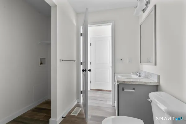 a bathroom with a granite countertop toilet sink and a mirror