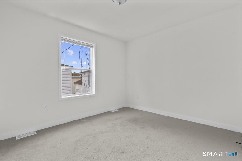 55 Sugar Street, Unit 14 Newtown, CT 06470 - Photo 13 of 18 a view of an empty room with a window