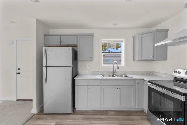 a kitchen with a sink and a refrigerator