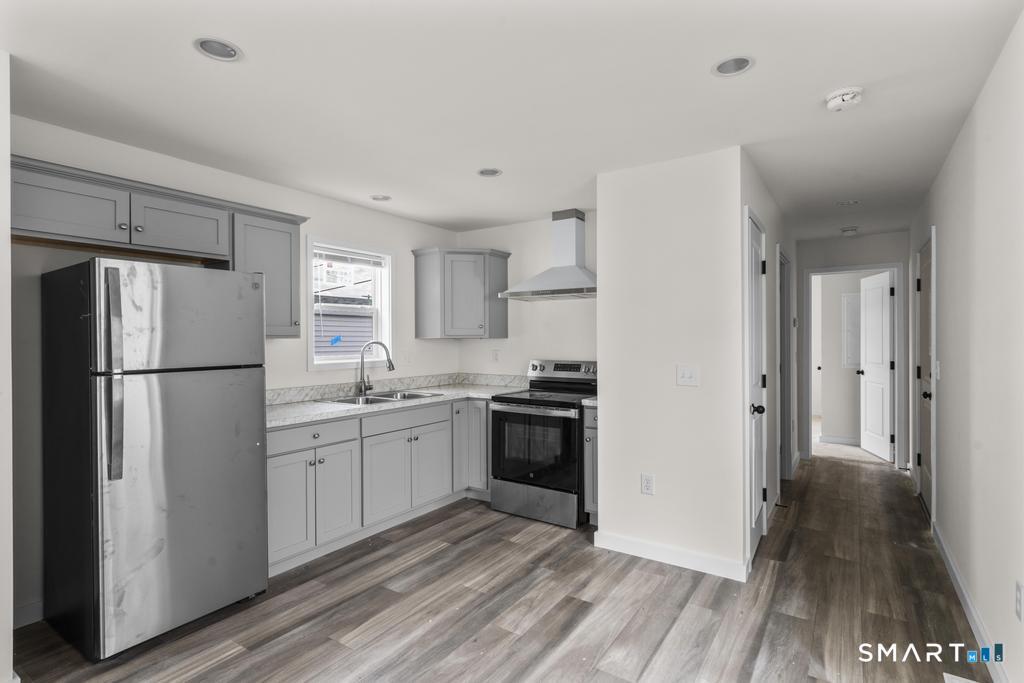 55 Sugar Street, Unit 14 Newtown, CT 06470 - Photo 3 of 18 a kitchen with a refrigerator a sink and dishwasher