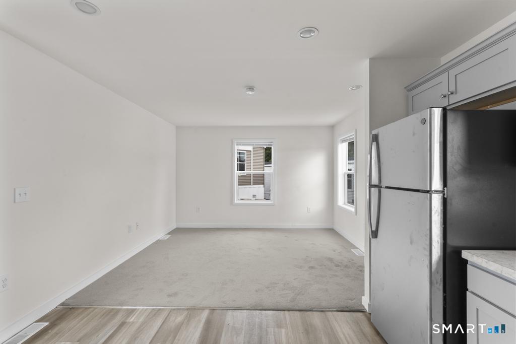 55 Sugar Street, Unit 14 Newtown, CT 06470 - Photo 5 of 18 a view of an empty room with a window