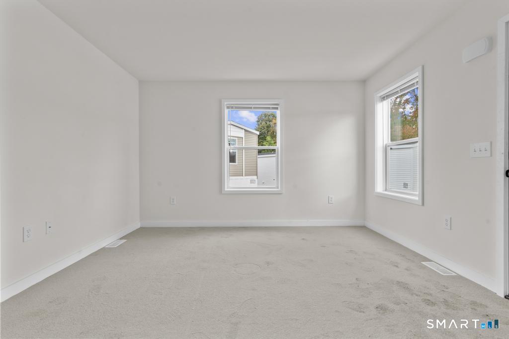 55 Sugar Street, Unit 14 Newtown, CT 06470 - Photo 7 of 18 a view of an empty room with a window