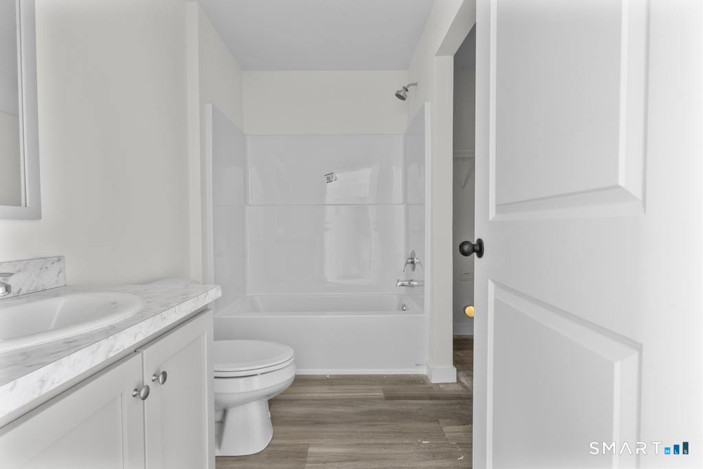 55 Sugar Street, Unit 14 Newtown, CT 06470 - Photo 10 of 18 a bathroom with a sink a toilet and shower