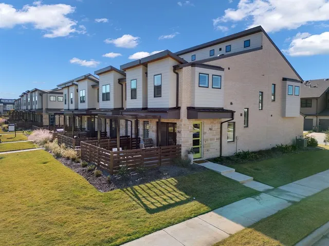 a front view of a house with a garden and plants