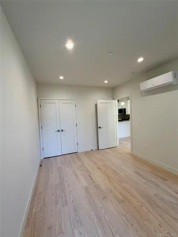 an empty room with windows and closet