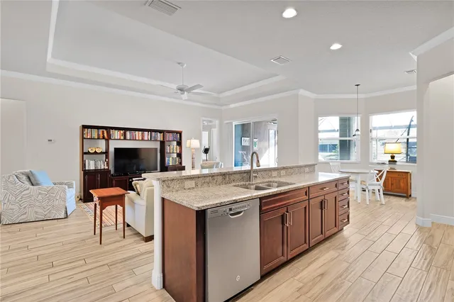 a large kitchen with stainless steel appliances kitchen island granite countertop a large island in the center