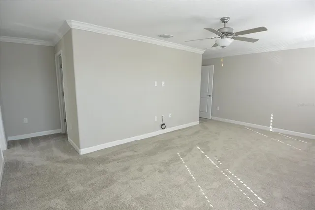 a view of an empty room with a ceiling fan