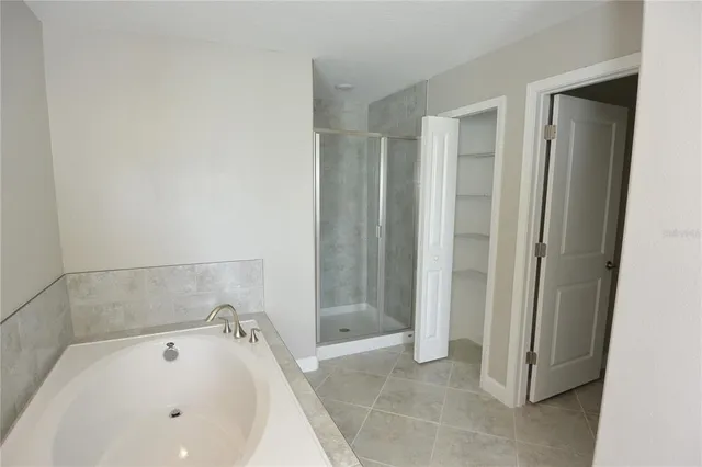 a bathroom with a bathtub and shower