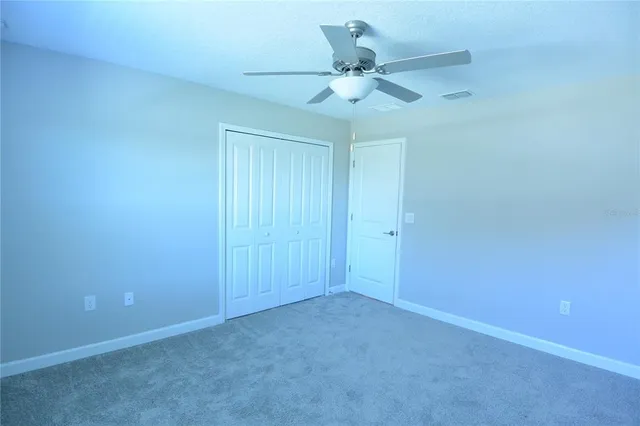 an empty room with a fan and a fan